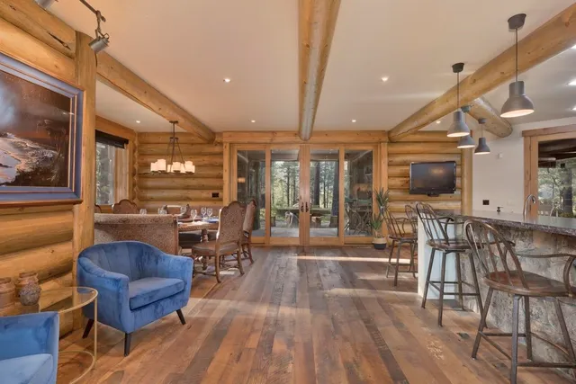 a living room with furniture and a floor to ceiling window