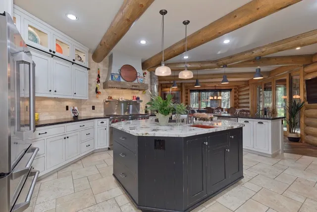 a spacious bathroom with a granite countertop sink and a mirror