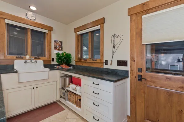 a bathroom with a granite countertop toilet sink and mirror