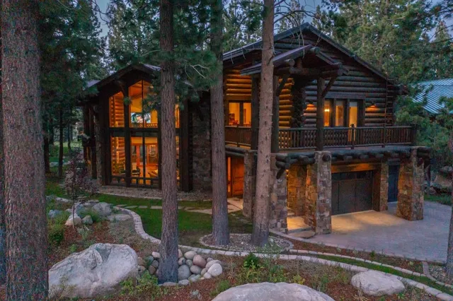 a living room with furniture a flat screen tv and floor to ceiling window