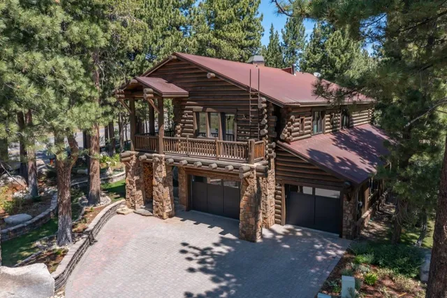 a dining room with furniture a flat screen tv and large windows