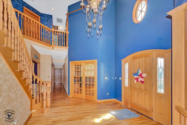 a view of staircase with railing and white walls