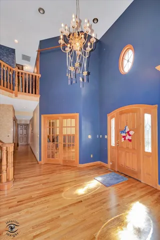 a view of a room with furniture wooden floor and chandelier