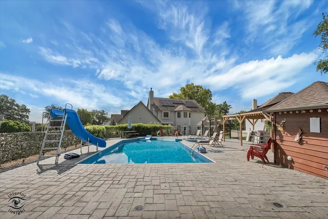 a white house that has a tree in front of it