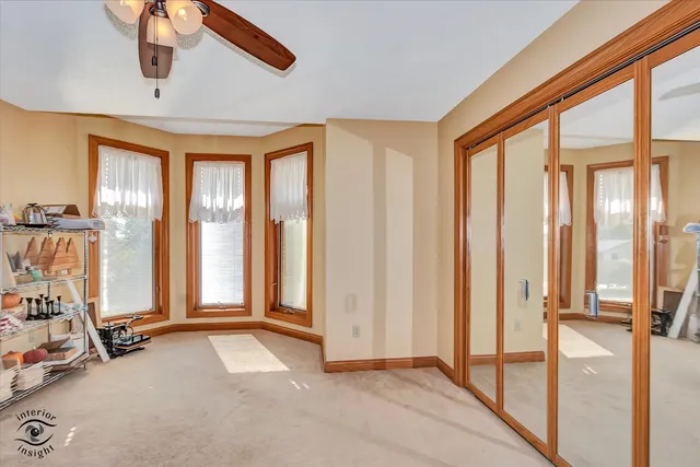 a bathroom with a granite countertop double vanity sink and a mirror