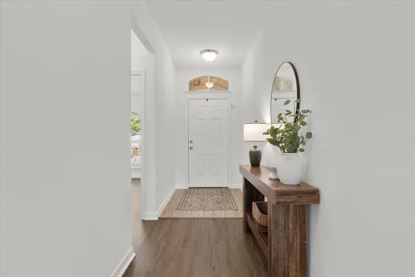 a living room with furniture kitchen view and a chandelier