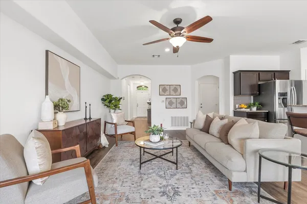 a kitchen with stainless steel appliances granite countertop a sink a stove and a wooden cabinets