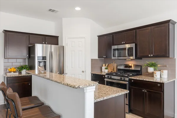 a kitchen with a stove and a microwave
