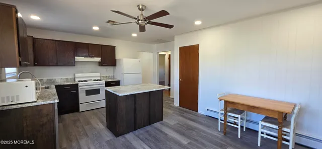 a kitchen with a stove a sink and a refrigerator