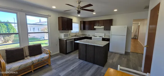 a kitchen with stainless steel appliances granite countertop a refrigerator and a stove top oven