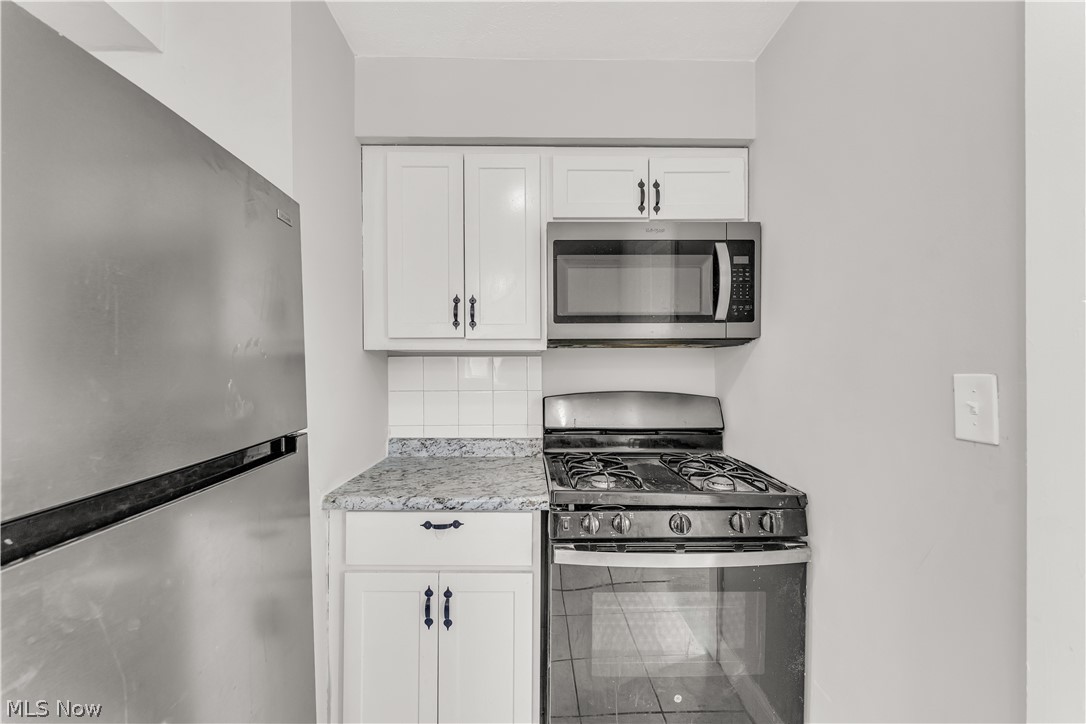 2521 Greenvale Road Cleveland, OH 44121 - Photo 12 of 23 Stainless steel gas range with overhead microwave