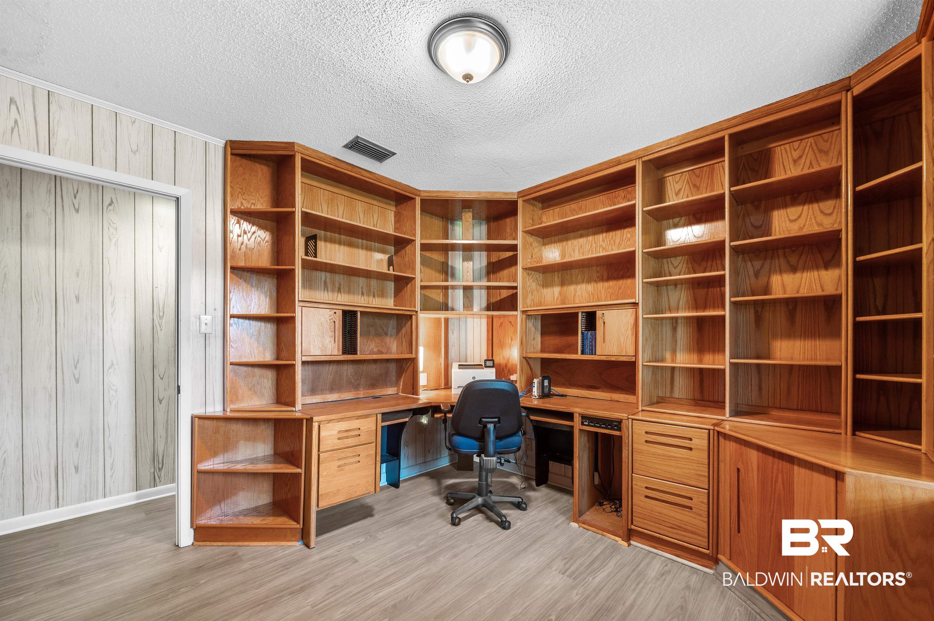 610 East Walker Avenue Foley, AL 36535 - Photo 24 of 38 Office space featuring light wood-style floors, a textured ceiling, wood walls, crown molding, and built in study area