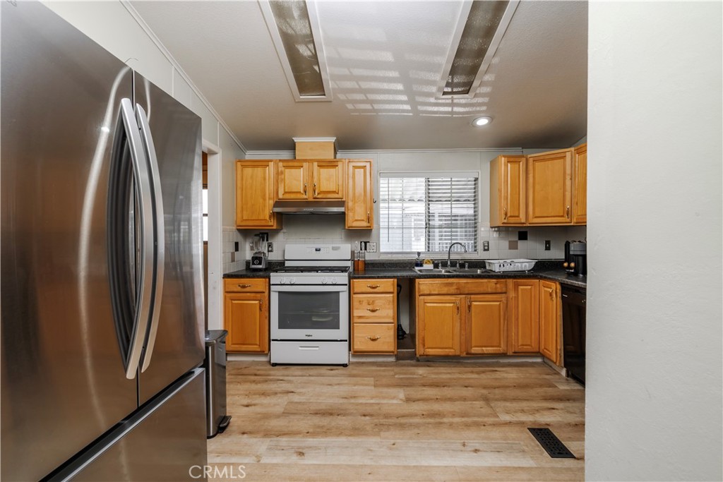 10350 Base Line Road, Unit 192 Rancho Cucamonga, CA 91701 - Photo 16 of 35 a kitchen with stainless steel appliances a refrigerator sink and microwave