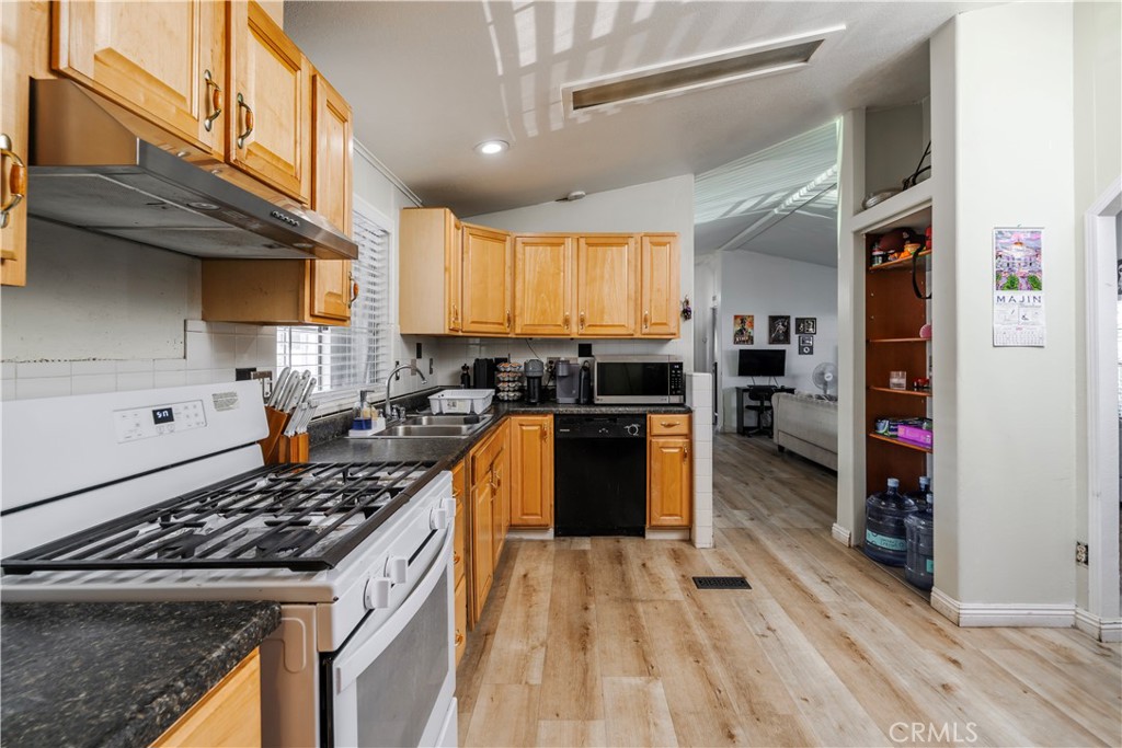10350 Base Line Road, Unit 192 Rancho Cucamonga, CA 91701 - Photo 18 of 35 a kitchen with stainless steel appliances granite countertop a stove a sink and a refrigerator