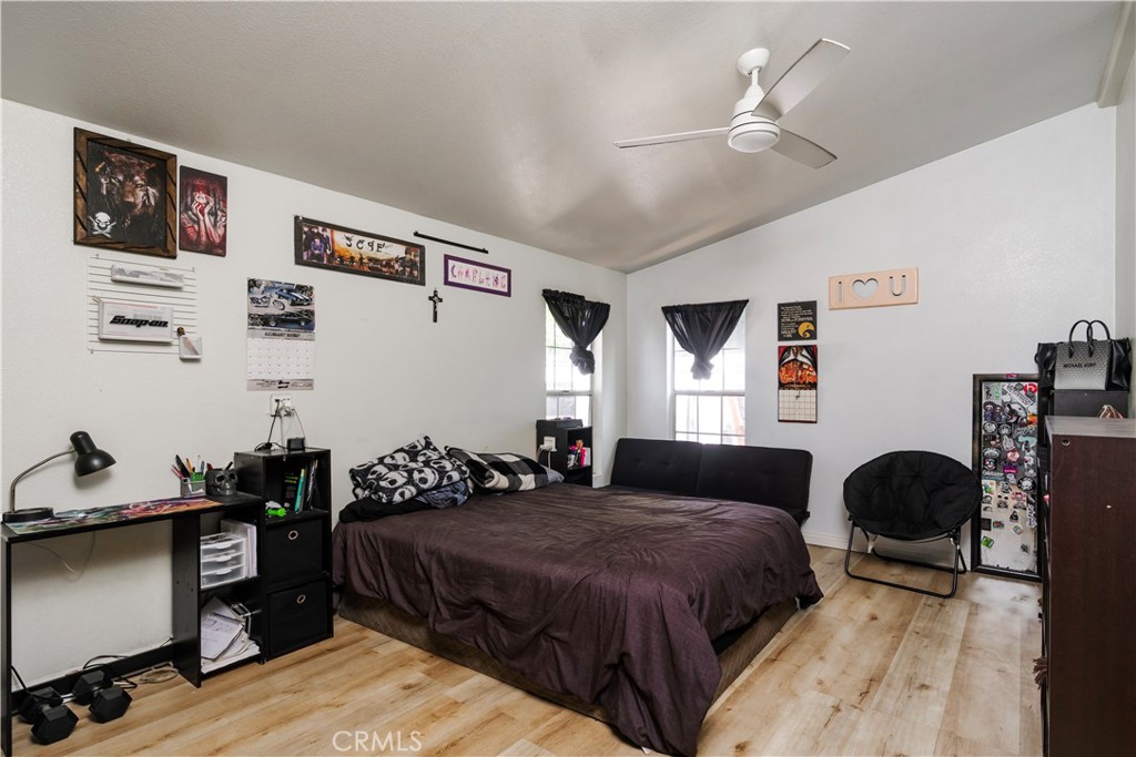 10350 Base Line Road, Unit 192 Rancho Cucamonga, CA 91701 - Photo 20 of 35 a bedroom with a bed and wooden floor