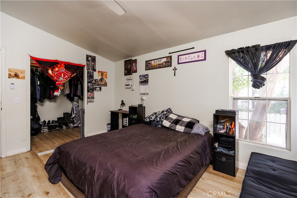 10350 Base Line Road, Unit 192 Rancho Cucamonga, CA 91701 - Photo 21 of 35 a bedroom with a bed and wooden floor