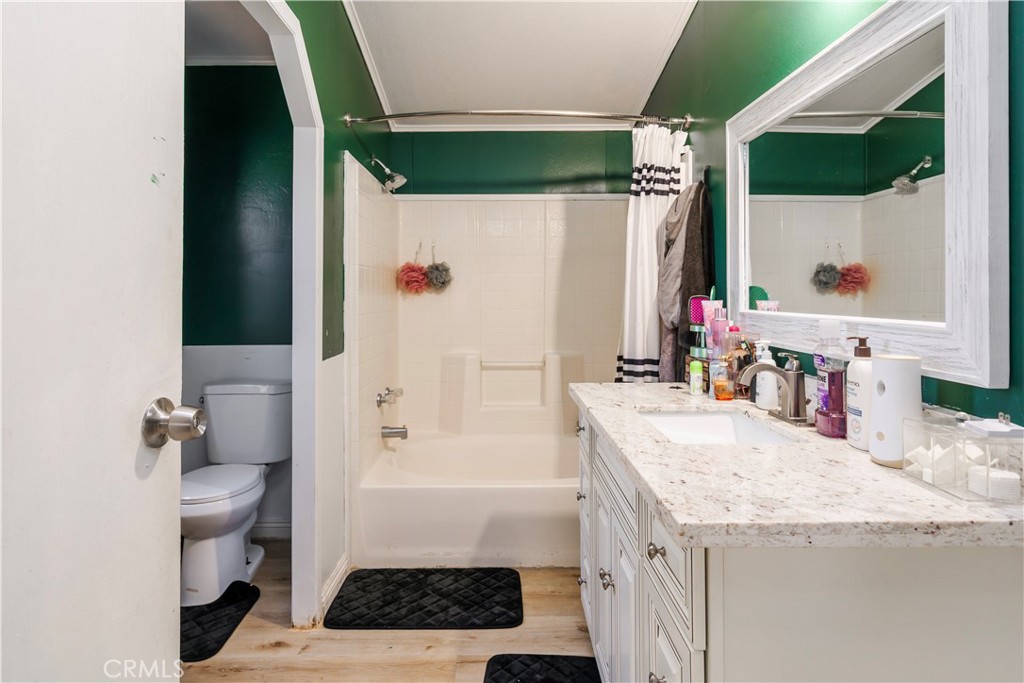 10350 Base Line Road, Unit 192 Rancho Cucamonga, CA 91701 - Photo 23 of 35 a bathroom with a granite countertop sink a toilet and shower