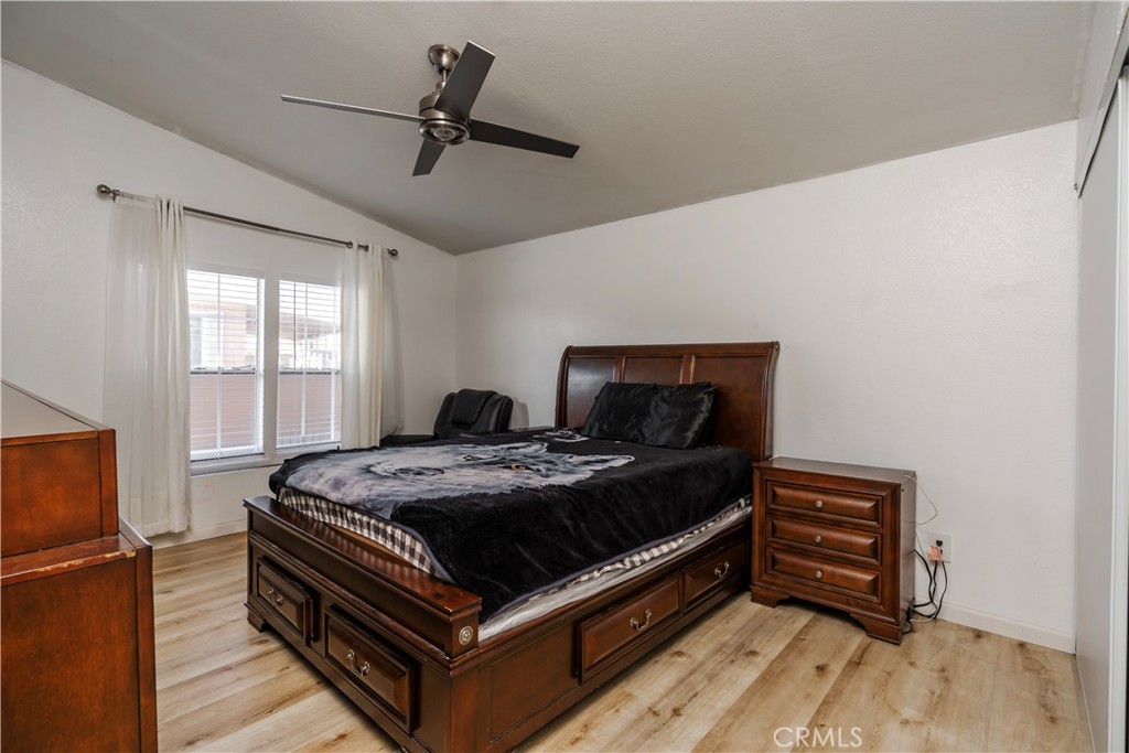 10350 Base Line Road, Unit 192 Rancho Cucamonga, CA 91701 - Photo 28 of 35 a bed room with a bed and a chandelier