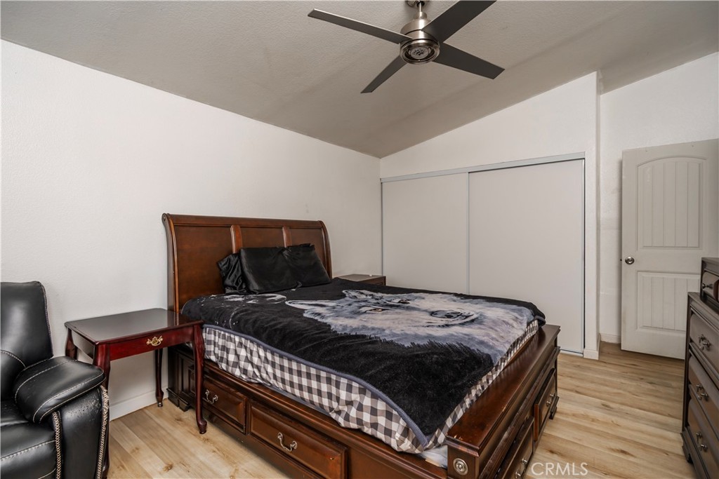 10350 Base Line Road, Unit 192 Rancho Cucamonga, CA 91701 - Photo 29 of 35 a bedroom with a bed and wooden floor