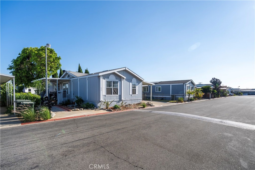 10350 Base Line Road, Unit 192 Rancho Cucamonga, CA 91701 - Photo 4 of 35 a wooden bench sitting in front of a house