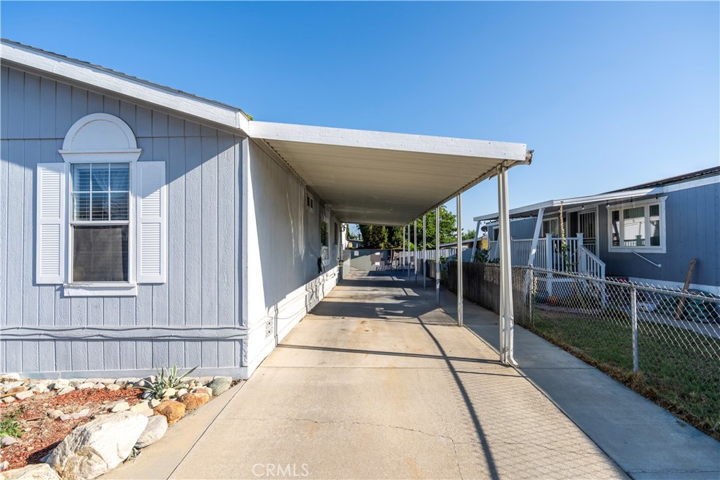 10350 Base Line Road, Unit 192 Rancho Cucamonga, CA 91701 - Photo 5 of 35 a view of a porch with furniture and floor to ceiling window