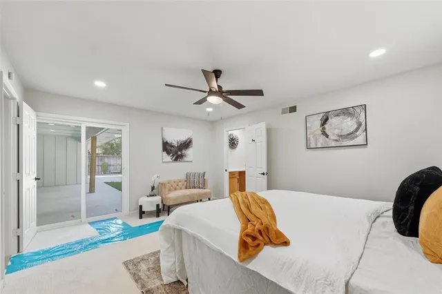 a bedroom with a large bed and a chandelier