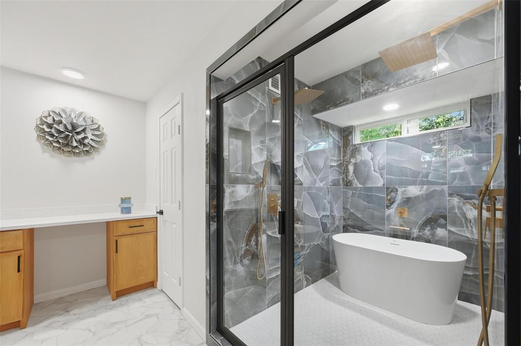 2709 Quail Ridge Drive Carrollton, TX 75006 - Photo 14 of 28 a bathroom with a granite countertop sink a toilet and shower