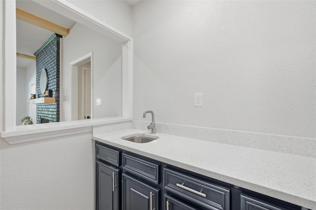 2709 Quail Ridge Drive Carrollton, TX 75006 - Photo 7 of 28 a bathroom with a sink and a mirror
