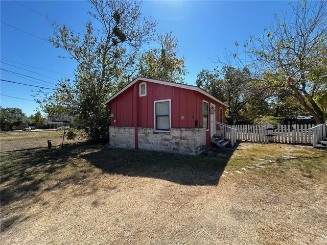 a view of a house with a yard covered in snow