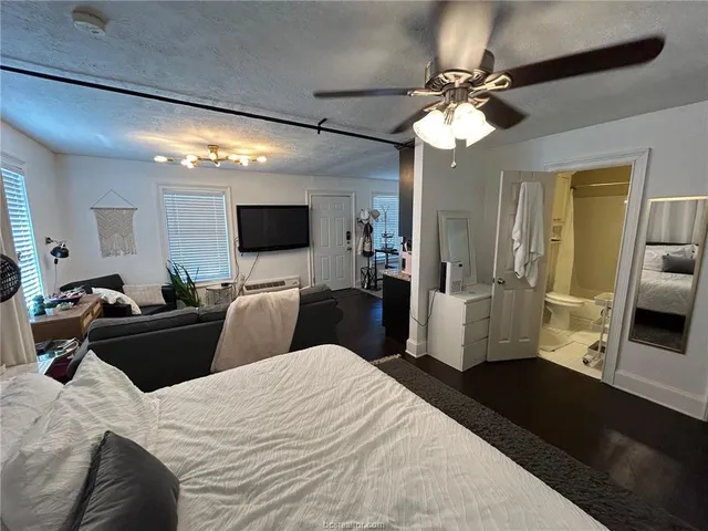 a bedroom with a bed and a large mirror