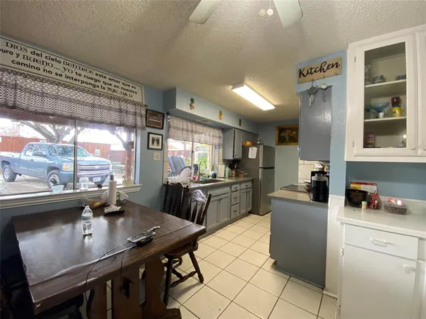 a kitchen with a table chairs and microwave