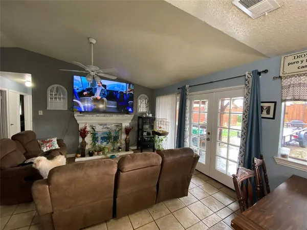 a living room with fireplace furniture and a flat screen tv