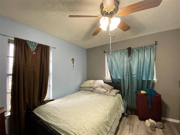 a bedroom with a bed and a chandelier