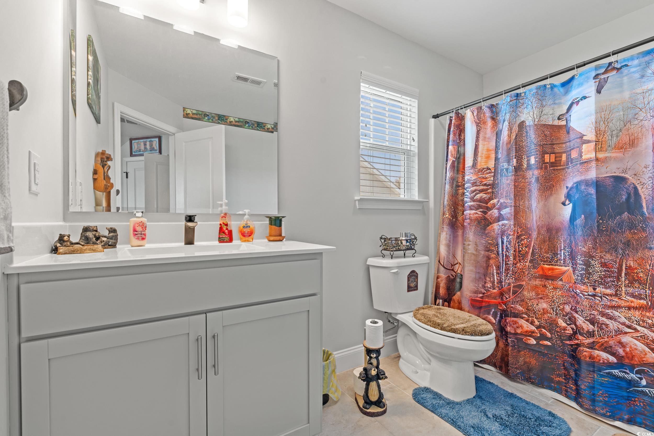 132 Fox Den Drive Murrells Inlet, SC 29576 - Photo 18 of 35 Full bath with a shower with curtain, vanity, and light tile patterned flooring
