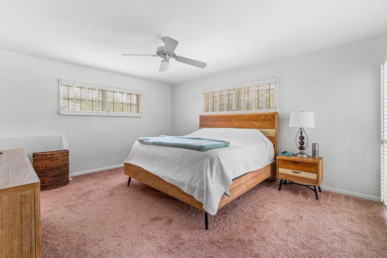 1350 Southwest 13th Place Boca Raton, FL 33486 - Photo 13 of 26 a bedroom with a bed and a couch