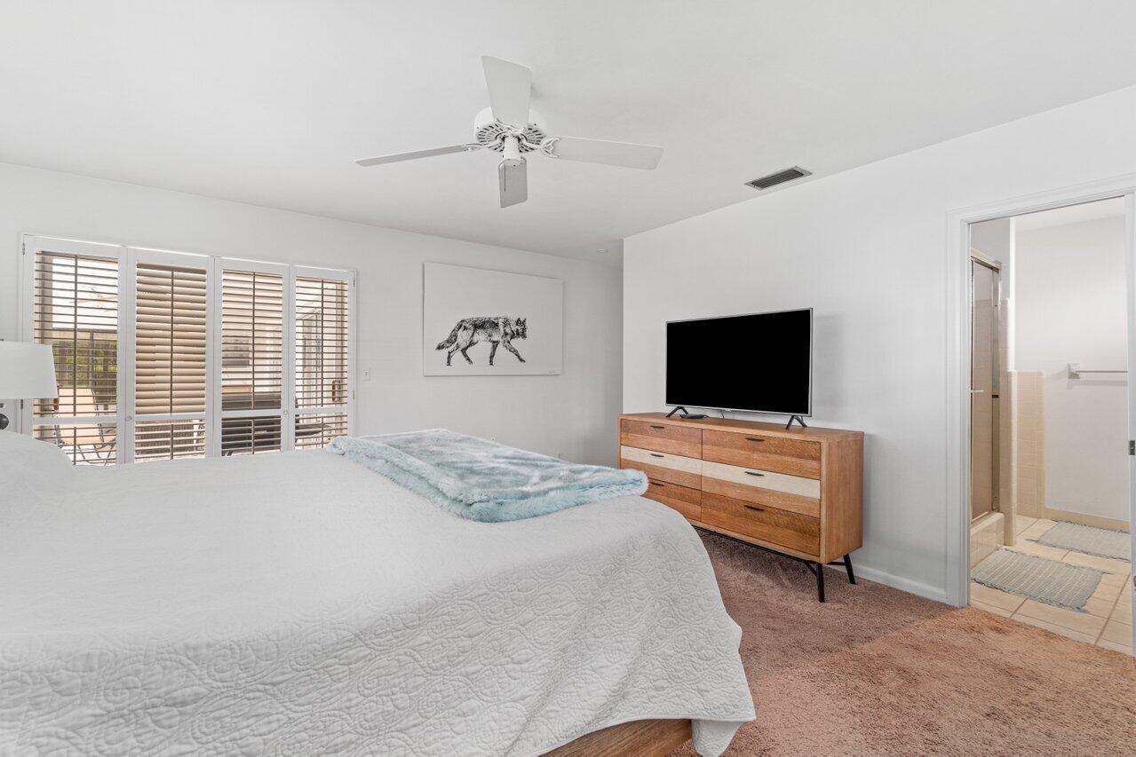 1350 Southwest 13th Place Boca Raton, FL 33486 - Photo 14 of 26 a bedroom with a bed and a flat screen tv