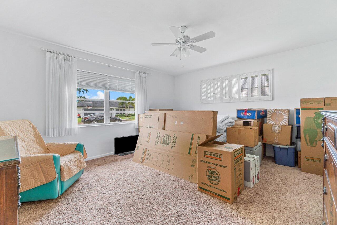 1350 Southwest 13th Place Boca Raton, FL 33486 - Photo 18 of 26 a living room with furniture and a fireplace