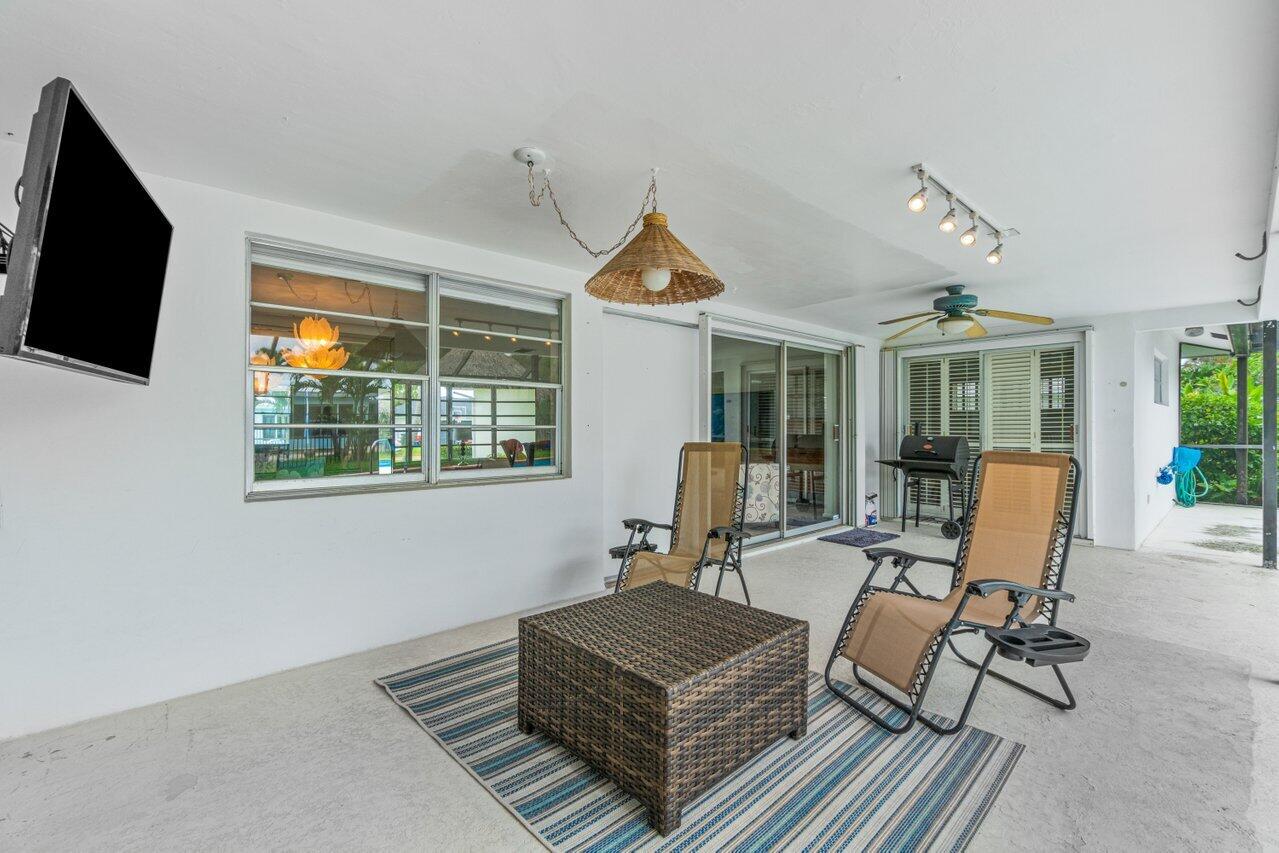 1350 Southwest 13th Place Boca Raton, FL 33486 - Photo 21 of 26 a living room with furniture and a flat screen tv
