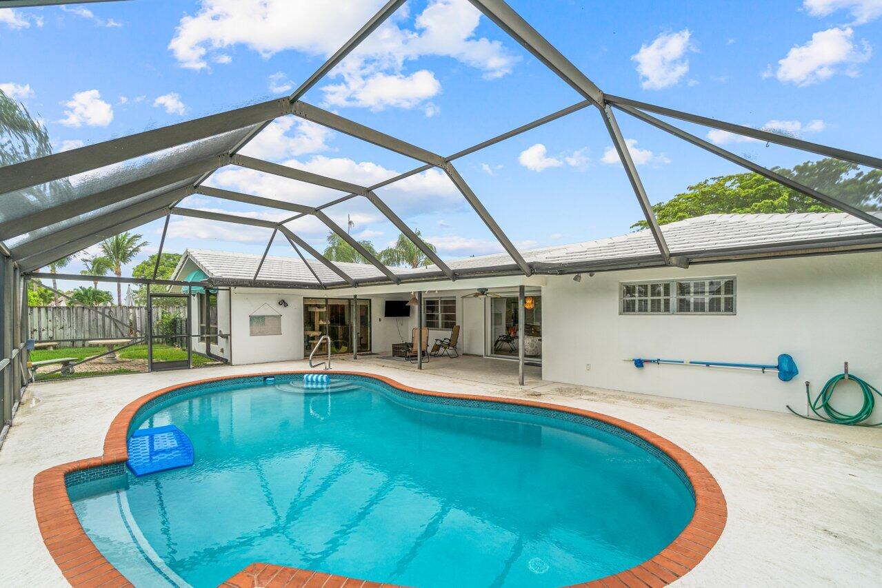 1350 Southwest 13th Place Boca Raton, FL 33486 - Photo 24 of 26 a view of a swimming pool with a patio