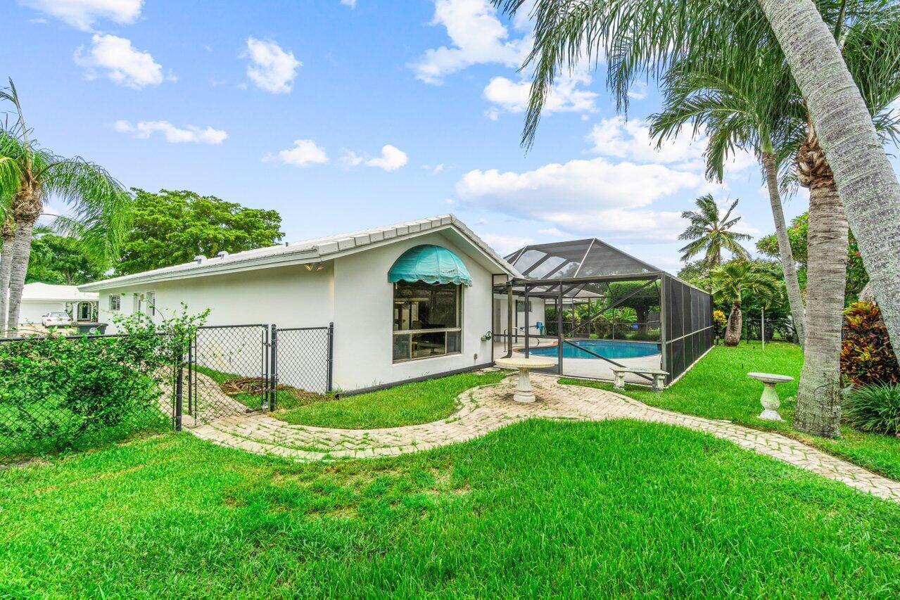 1350 Southwest 13th Place Boca Raton, FL 33486 - Photo 26 of 26 a view of a house with a yard and sitting area