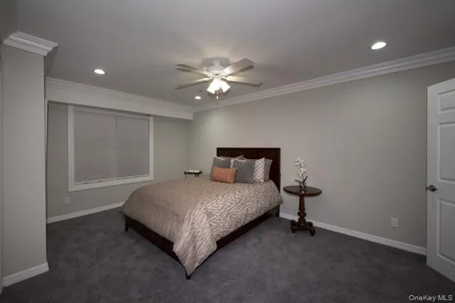 a bedroom with a bed and a ceiling fan