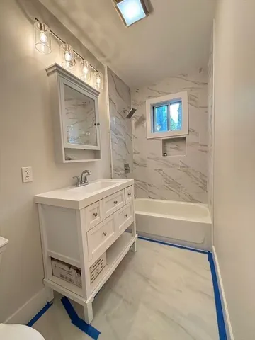 a bathroom with a sink a mirror and a bathtub