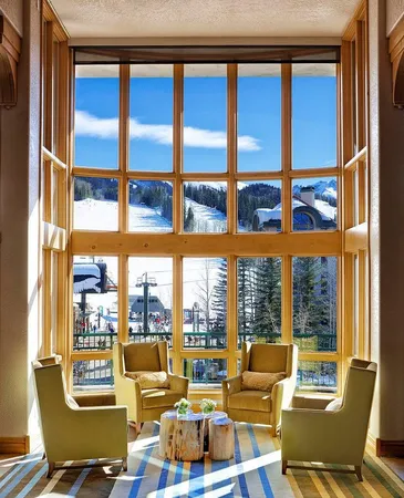 a living room with windows city view