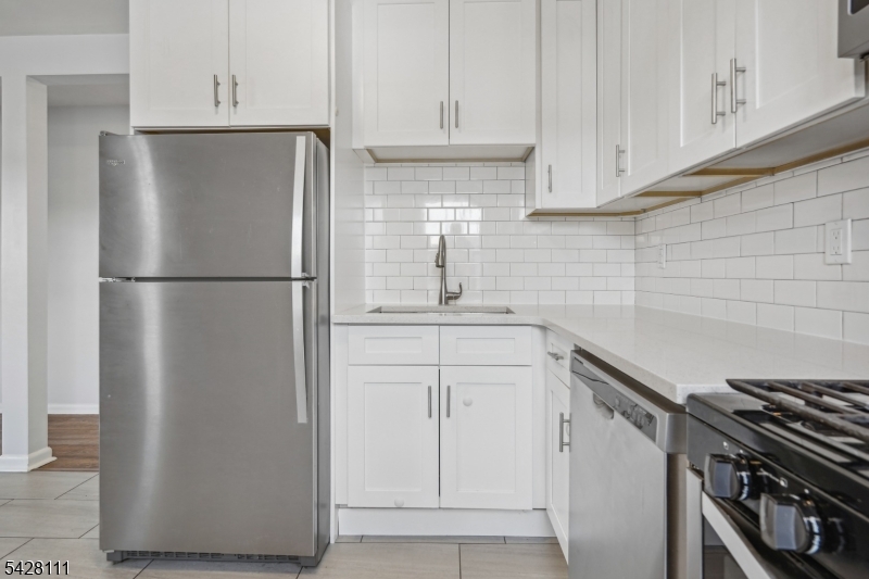 60 2nd Street South Orange, NJ 07079 - Photo 7 of 18 a white refrigerator freezer sitting inside of a kitchen