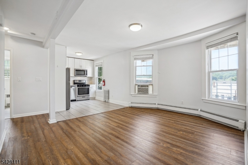 60 2nd Street South Orange, NJ 07079 - Photo 8 of 18 an empty room with wooden floor and a window