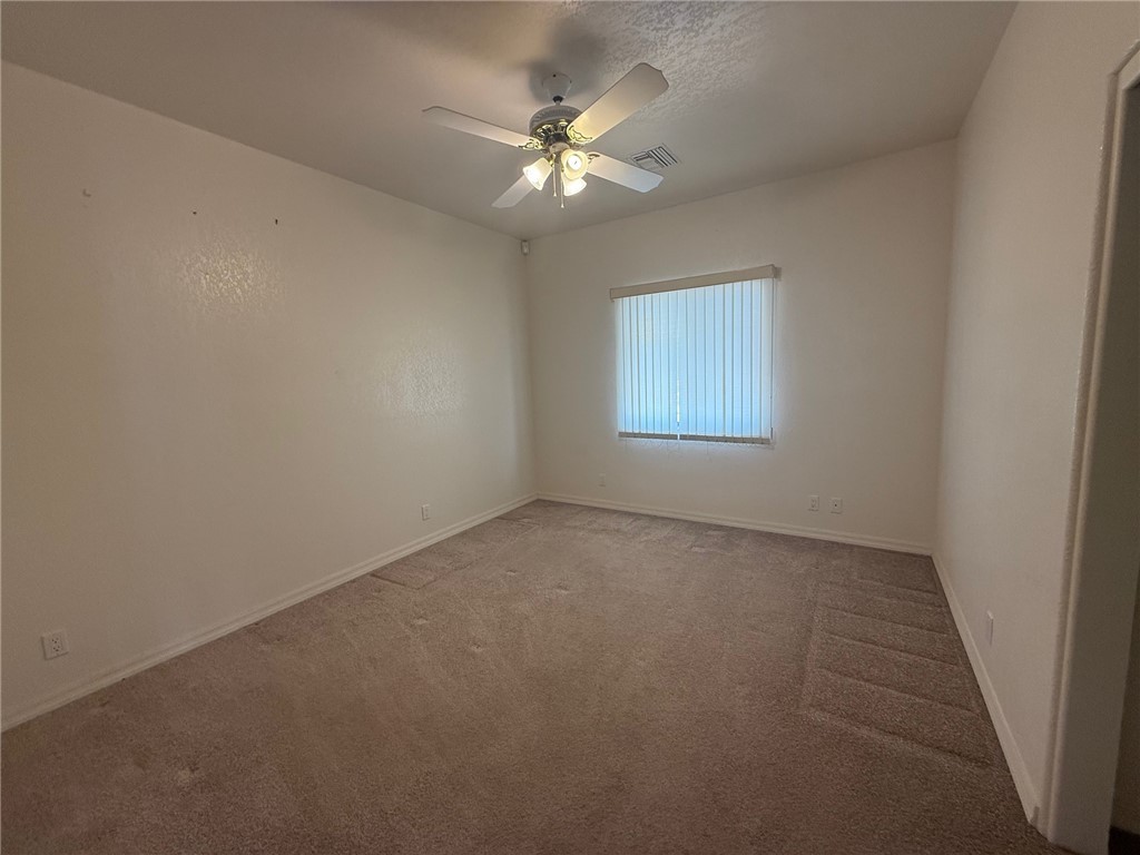 1845 Dunlap Road Fort Mohave, AZ 86426 - Photo 9 of 16 Carpeted empty room featuring a ceiling fan and a textured ceiling