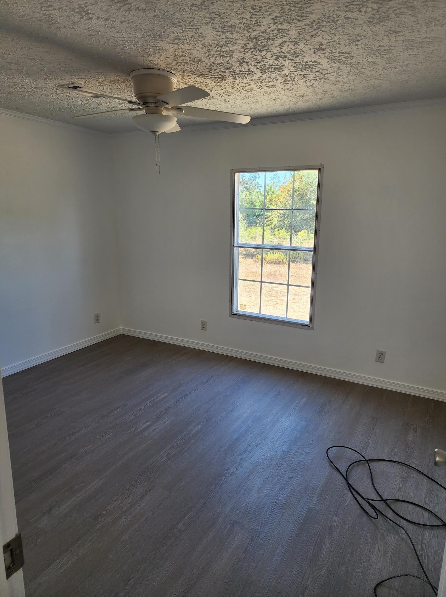 268 Don Graff Road Freeport, FL 32439 - Photo 15 of 20 an empty room with wooden floor and windows