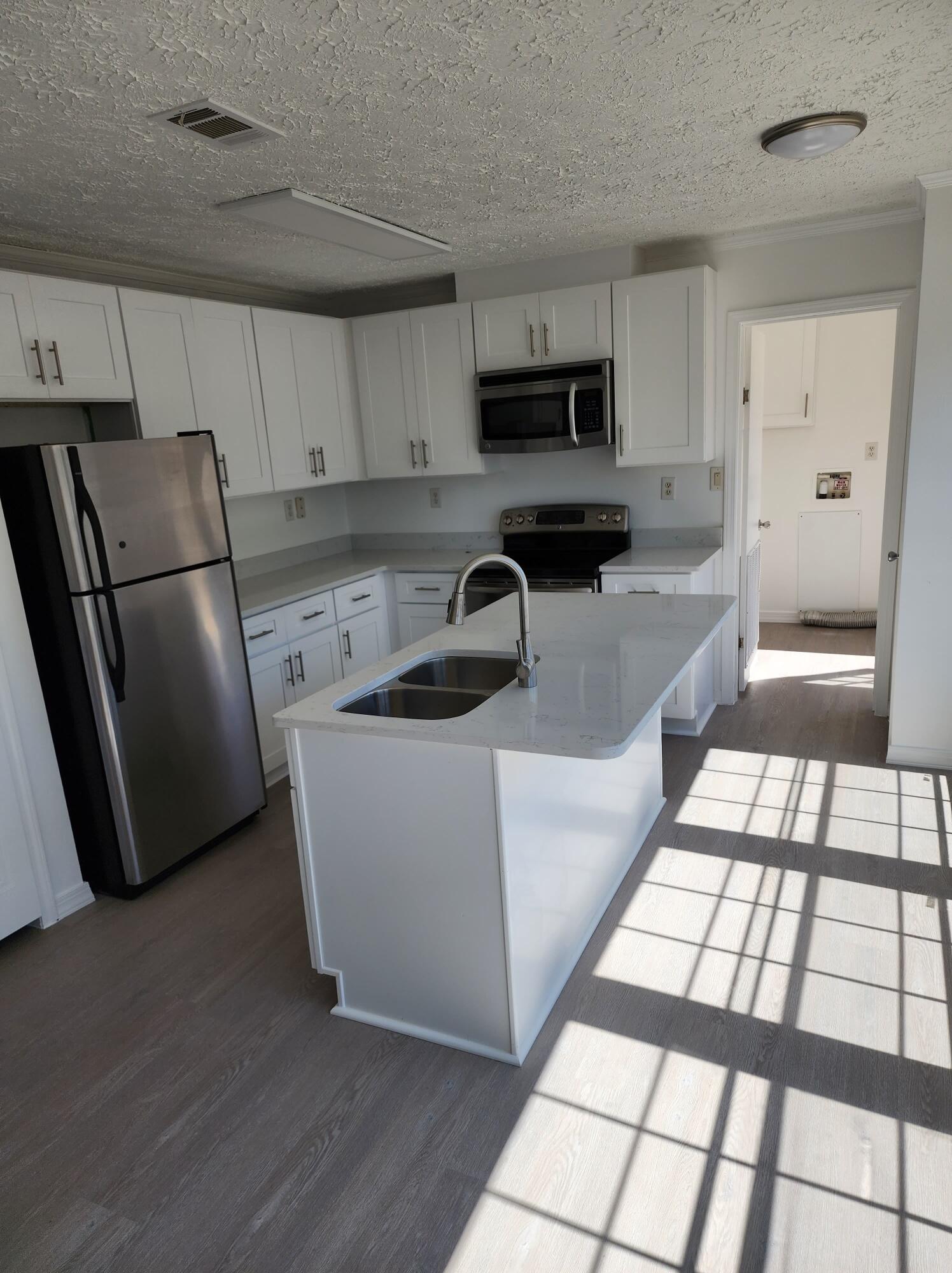 268 Don Graff Road Freeport, FL 32439 - Photo 4 of 20 a kitchen with stainless steel appliances a refrigerator a sink a stove a microwave and cabinets