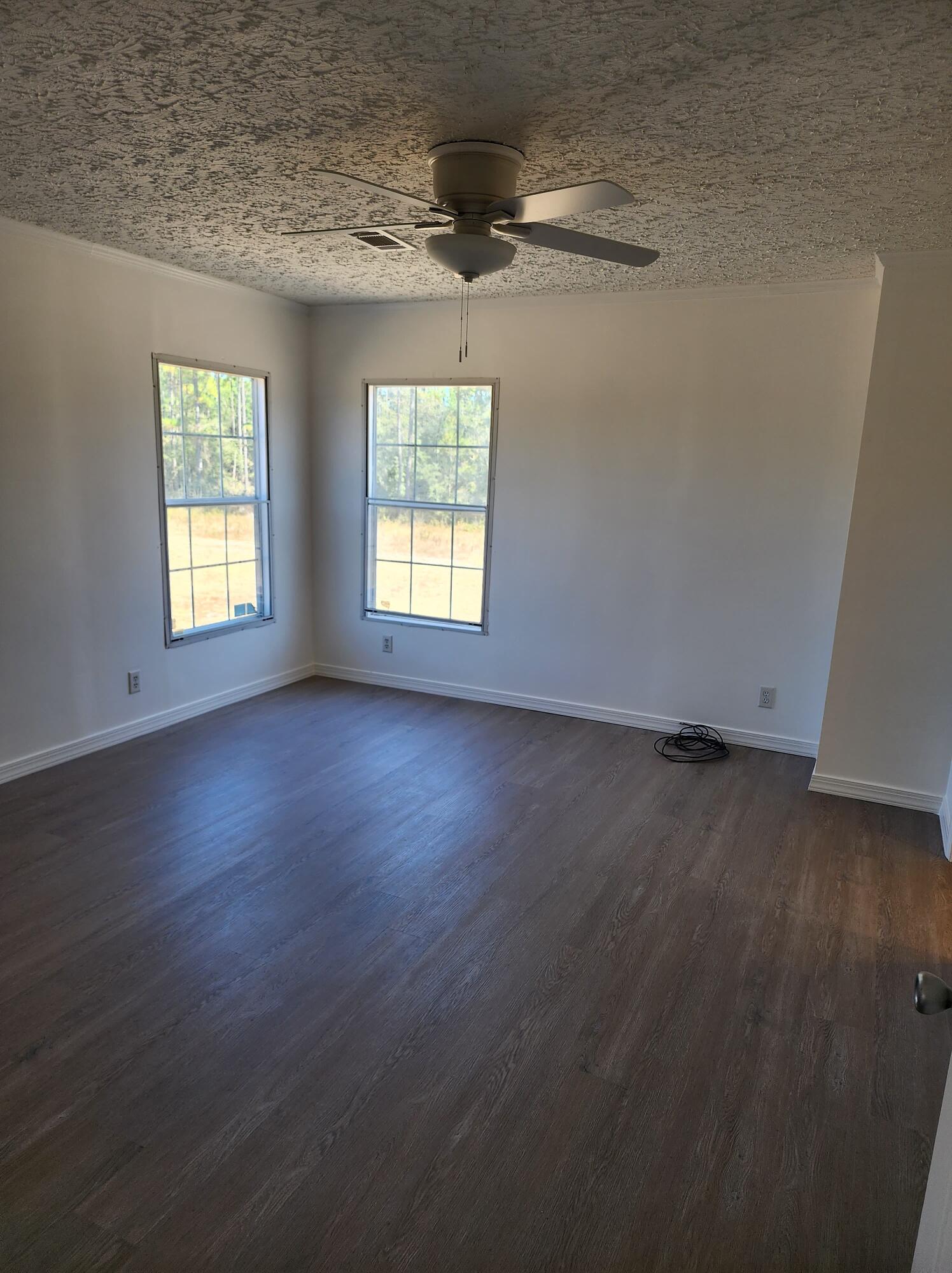 268 Don Graff Road Freeport, FL 32439 - Photo 9 of 20 an empty room with wooden floor and windows