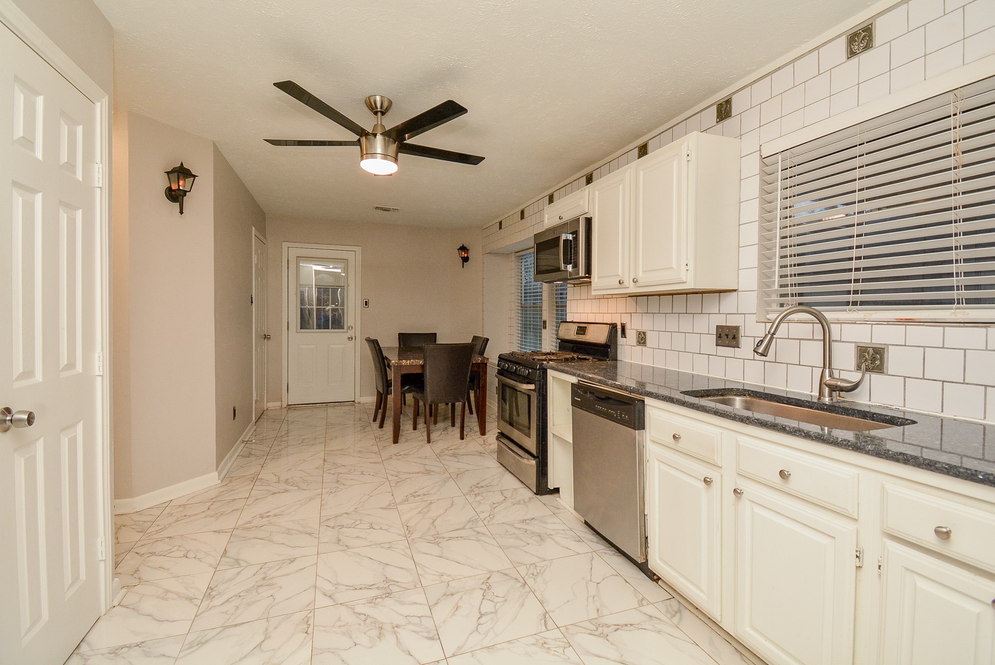 22906 Indian Ridge Drive Katy, TX 77450 - Photo 11 of 26 a kitchen with stainless steel appliances granite countertop a sink a stove and a refrigerator